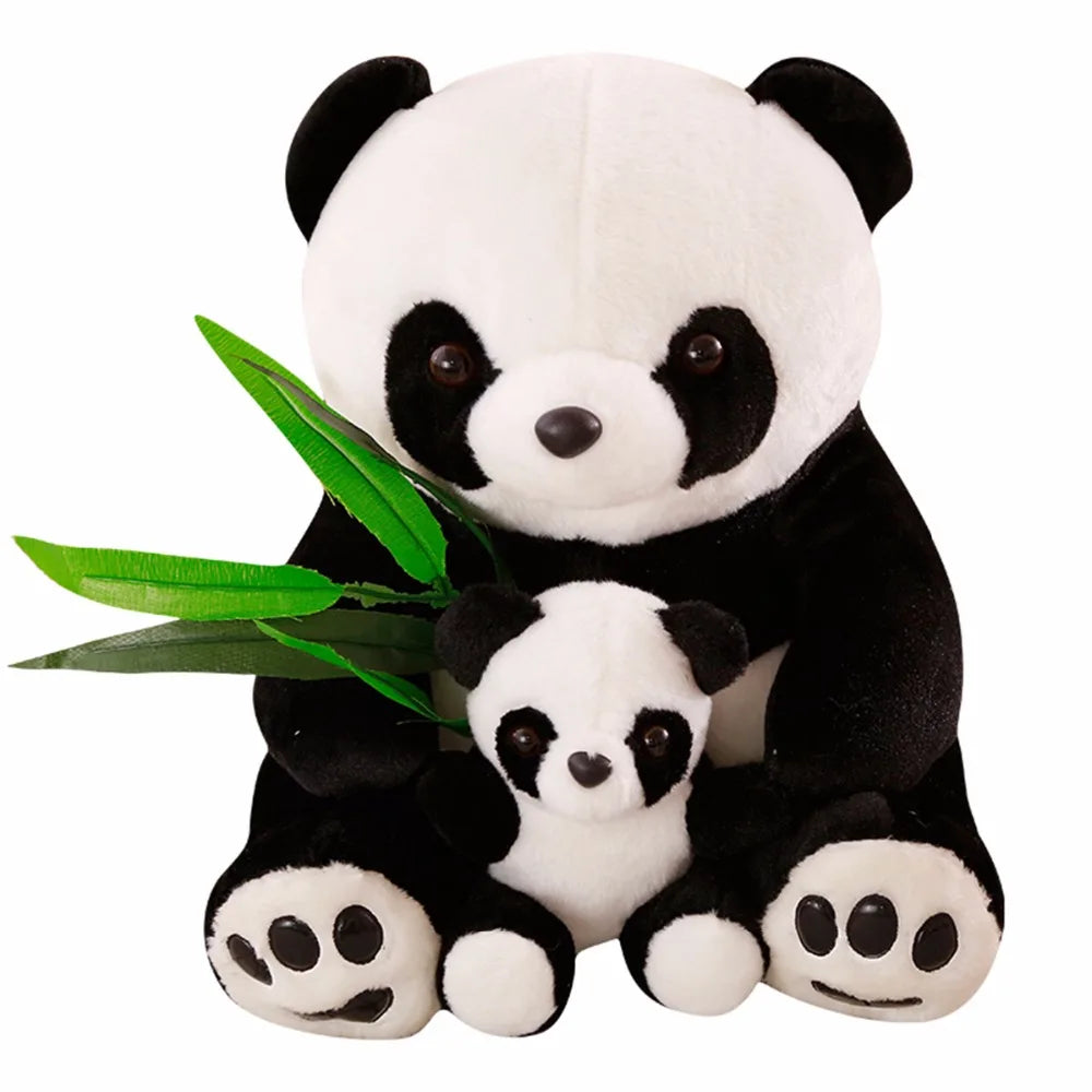 Plush panda toy holding a smaller plush panda and green leaves on a white background