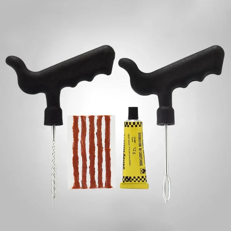 Two black handled tire repair tools with a tube of yellow glue and a red strip on a gray background