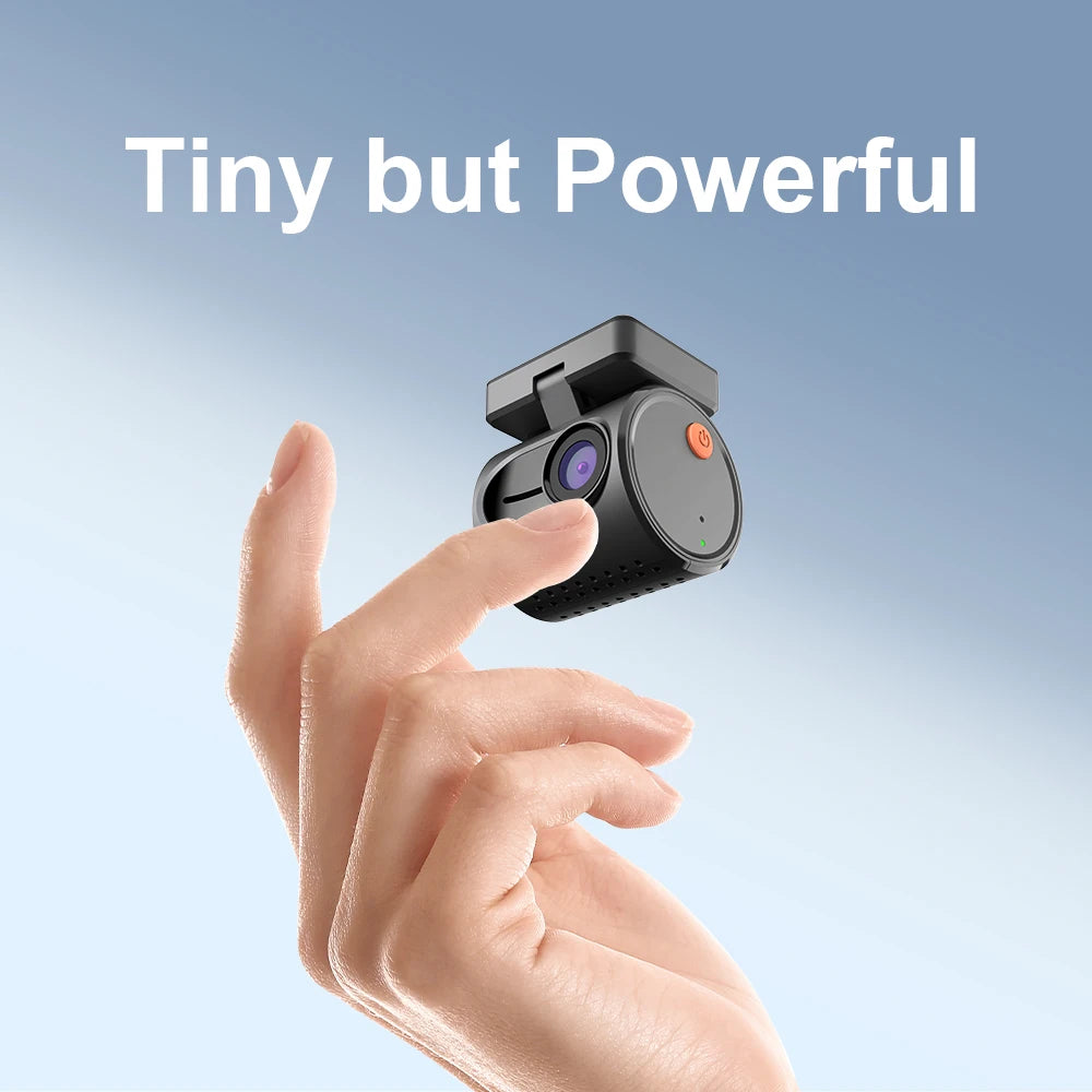 A hand holding a small black dash cam against a soft blue gradient background with the text 'Tiny but Powerful' at the top.