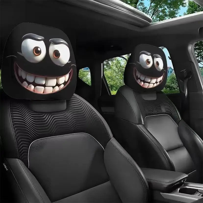 Car headrest covers with cartoonish faces in a vehicle interior.